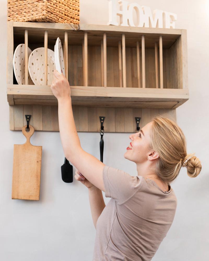 Woman taking plate from shelf 